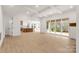 Open-concept living area featuring coffered ceilings, light wood floors, and sliding glass doors to an outdoor space at 4095 Kingfisher Dr, York, SC 29745