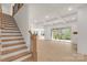Open-concept layout with staircase, coffered ceiling, and sliding glass doors at 4095 Kingfisher Dr, York, SC 29745