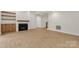 Bright living room with fireplace, light wood floors, and open staircase at 4095 Kingfisher Dr, York, SC 29745