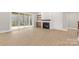 Modern living room with light wood floors, shiplap accent wall with fireplace, and sliding glass doors at 4095 Kingfisher Dr, York, SC 29745