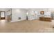 Open living space showcasing a wooden staircase and a modern kitchen with white cabinets and island at 4095 Kingfisher Dr, York, SC 29745
