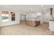 Bright open concept layout with modern lighting, light wood floors, and kitchen island with a farmhouse sink at 4095 Kingfisher Dr, York, SC 29745