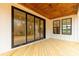Stylish outdoor patio with a wood paneled ceiling and sliding glass doors at 4095 Kingfisher Dr, York, SC 29745