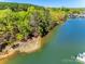 Beautiful waterfront lot featuring sandy beach access and mature trees, providing privacy and scenic views at 4095 Kingfisher Dr, York, SC 29745