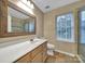 Bathroom featuring tile floors, a large mirror, sink, toilet, and walk-in shower at 5009 Ravens Ct, Matthews, NC 28104