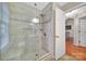 Bathroom featuring tile floors, tiled shower with a bench, and glass doors at 5009 Ravens Ct, Matthews, NC 28104