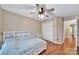 Bedroom featuring hardwood floors, ceiling fan, double windows, and a closet at 5009 Ravens Ct, Matthews, NC 28104