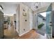 Inviting entryway with hardwood floors and stylish light fixture leading into the home at 5009 Ravens Ct, Matthews, NC 28104