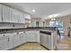 Functional kitchen featuring stainless steel dishwasher, white cabinets, and granite counters at 5009 Ravens Ct, Matthews, NC 28104