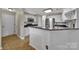 Well-lit kitchen with white cabinets, granite countertops, and modern appliances at 5009 Ravens Ct, Matthews, NC 28104
