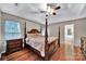 Main bedroom with a four post bed, hardwood floors, and a ceiling fan at 5009 Ravens Ct, Matthews, NC 28104