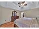 Spacious main bedroom featuring a tray ceiling, ceiling fan, and elegant wooden furniture set at 5009 Ravens Ct, Matthews, NC 28104