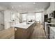 Stylish kitchen with a large center island, stainless steel appliances, and abundant natural light at 5030 Grain Orchard Rd # 3025C, Indian Trail, NC 28079