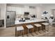 Modern kitchen boasts white cabinets, stainless steel appliances, and a spacious island with seating at 5030 Grain Orchard Rd # 3025C, Indian Trail, NC 28079