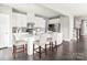 Spacious kitchen featuring a large island with bar seating, white cabinetry, and modern appliances at 522 Lenswood Ct, Denver, NC 28037