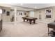 Spacious finished basement featuring a billiards table, bar stools, and stylish decor for recreation at 521 Lenswood Ct, Denver, NC 28037