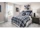 Cozy bedroom with plush carpet, a large window, and a comfortable bed with stylish bedding and decor at 521 Lenswood Ct, Denver, NC 28037