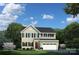 Charming two-story home featuring a manicured lawn and an attached two-car garage at 521 Lenswood Ct, Denver, NC 28037