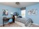 Whimsical bedroom with blue walls, bicycle-themed decor, and a comfortable bed with patterned bedding at 523 Lenswood Ct, Denver, NC 28037