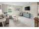 Comfortable bonus room featuring a couch, tv, and ample seating, perfect for relaxation at 523 Lenswood Ct, Denver, NC 28037