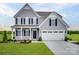 Inviting two-story home with gray siding, black shutters, and a two-car garage showcasing classic suburban charm at 523 Lenswood Ct, Denver, NC 28037