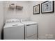 Convenient laundry room with side-by-side washer and dryer, plus upper storage for organization at 523 Lenswood Ct, Denver, NC 28037