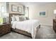 Serene bedroom with a plush bed, neutral tones, soft carpet, and natural light from a window at 523 Lenswood Ct, Denver, NC 28037