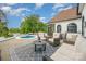 Relaxing back patio with outdoor seating, a grill, and beautiful views of the lawn and pool at 5400 Challisford Ln, Charlotte, NC 28226