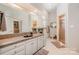 Bright bathroom features granite counters, cream-colored cabinets, and shower stall at 5400 Challisford Ln, Charlotte, NC 28226