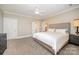 Bedroom boasts neutral tones, carpet, ensuite bathroom, and ceiling fan at 5400 Challisford Ln, Charlotte, NC 28226