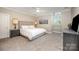 This bedroom offers neutral tones, carpet, and a large window at 5400 Challisford Ln, Charlotte, NC 28226