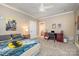 Light-filled bedroom with neutral tones, Batman decor, and ceiling fan at 5400 Challisford Ln, Charlotte, NC 28226