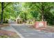 Gated community entrance with brick signage and mature trees at 5400 Challisford Ln, Charlotte, NC 28226