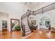 Grand foyer featuring a curved staircase, hardwood floors, and elegant details at 5400 Challisford Ln, Charlotte, NC 28226