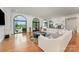 Bright living room featuring hardwood floors, white furniture, and large windows with an outdoor view at 5400 Challisford Ln, Charlotte, NC 28226