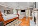 Spacious main bedroom with a fireplace, tray ceiling, hardwood floors, and a large window at 5400 Challisford Ln, Charlotte, NC 28226