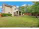 Large backyard with ample green space, featuring a patio area, fire pit, storage shed, and wooden fence at 544 Cool Creek Dr, Rock Hill, SC 29732