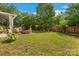 Spacious backyard featuring a well-maintained lawn, fire pit, privacy fence, and mature trees, perfect for outdoor living at 544 Cool Creek Dr, Rock Hill, SC 29732