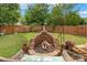 Backyard featuring a brick fire pit, seating, a wooden fence and a grill at 544 Cool Creek Dr, Rock Hill, SC 29732