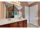 Bathroom featuring a double sink vanity, large mirror, tub with glass door, and neutral paint at 544 Cool Creek Dr, Rock Hill, SC 29732