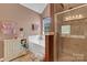 Bathroom with a shower and tub with decor in the shelving unit beside a window at 544 Cool Creek Dr, Rock Hill, SC 29732
