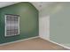 Bedroom with green walls and a carpeted floor with a door and window at 544 Cool Creek Dr, Rock Hill, SC 29732