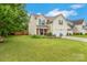 Charming two-story home featuring a well-manicured lawn, lush landscaping, and a welcoming front porch at 544 Cool Creek Dr, Rock Hill, SC 29732