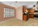 Cozy kitchen with warm-toned cabinets and stainless steel appliances, adjacent to an eating area at 544 Cool Creek Dr, Rock Hill, SC 29732