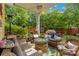 Outdoor patio seating area with a fire pit, ceiling fan, and surrounding greenery at 544 Cool Creek Dr, Rock Hill, SC 29732