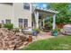 Outdoor patio with pergola, fan, string lights, and brick firepit, creating an inviting space for entertaining at 544 Cool Creek Dr, Rock Hill, SC 29732