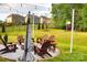Spacious backyard featuring a fire pit with seating and ambient lighting, ideal for outdoor entertaining at 6016 Willow Pin Ln, Huntersville, NC 28078