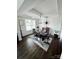 Formal dining room with coffered ceilings, dark hardwood floors, and a designer light fixture at 6016 Willow Pin Ln, Huntersville, NC 28078