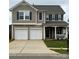 Charming two-story home featuring a two-car garage, covered porch, and well-maintained lawn at 6509 Ridgeview Commons Dr, Charlotte, NC 28269