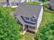 Aerial view of two-story home with well-maintained lawn and mature trees at 6541 Hasley Woods Dr, Huntersville, NC 28078